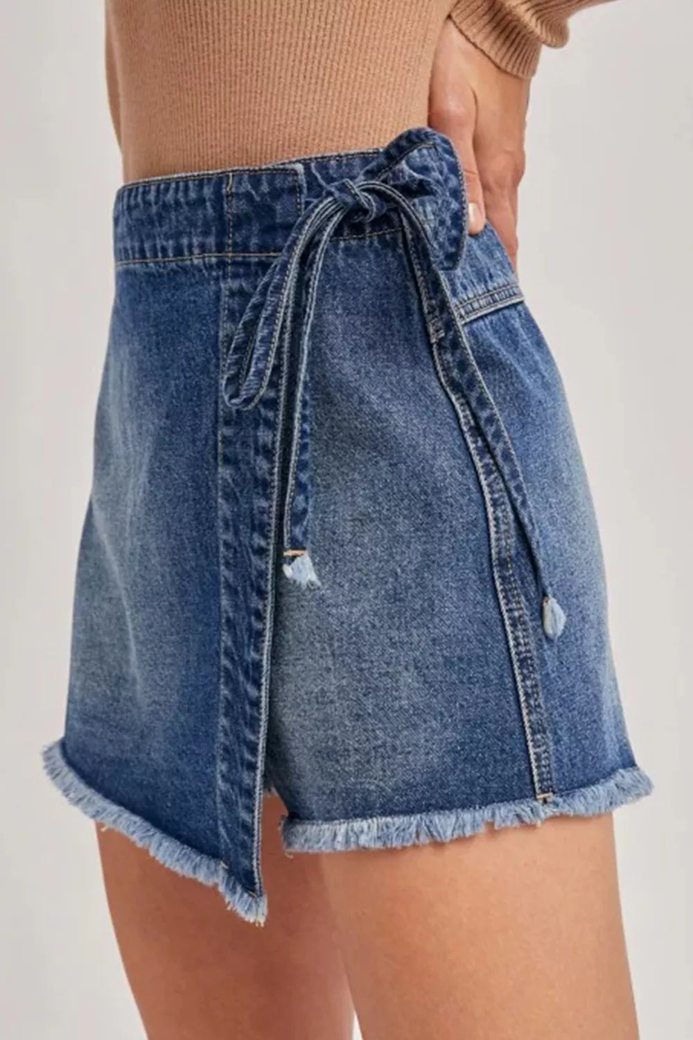Medium wash wrapped tie waist denim skort back view