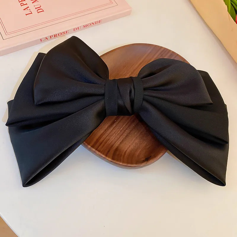 Bow cloth hair clip styled in hair