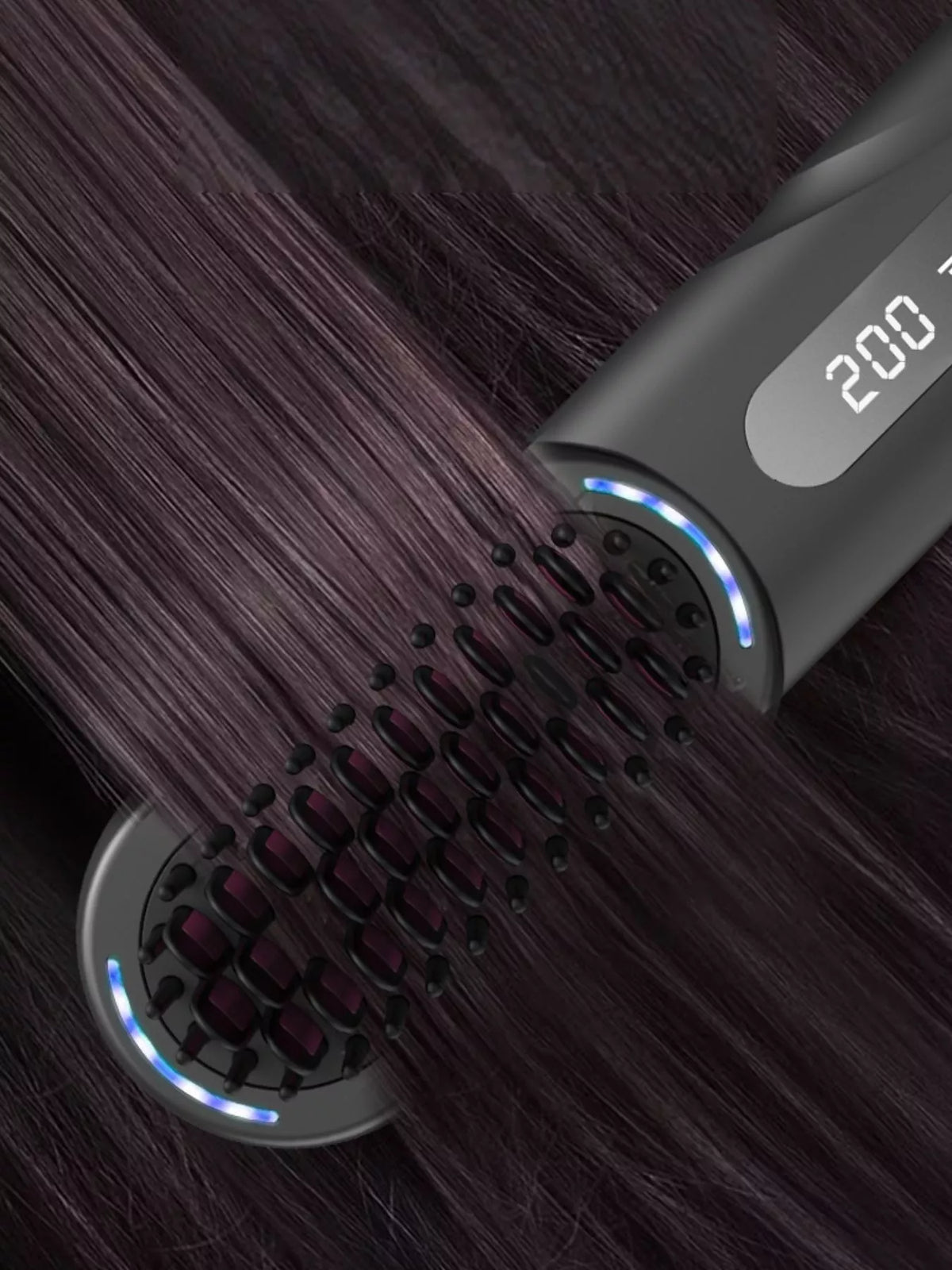 Woman smoothing hair with heated comb