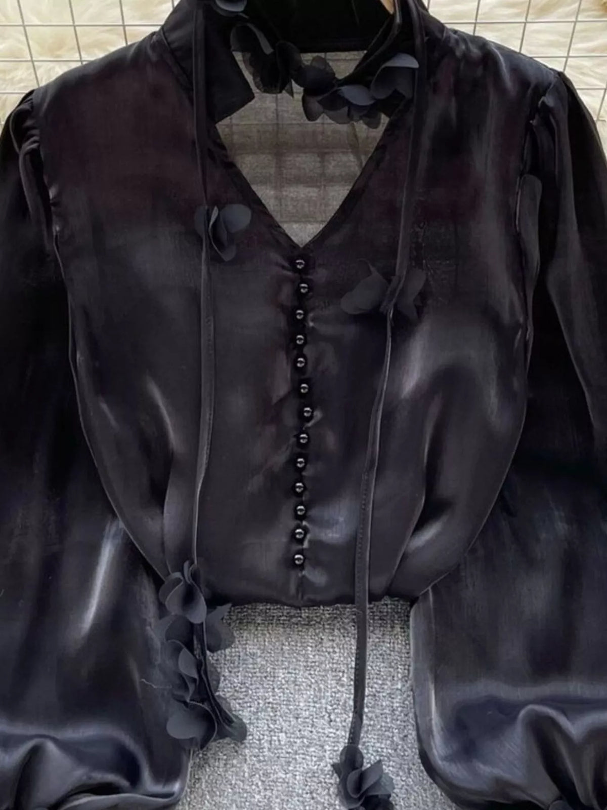Neckline and collar detail on the floral sheer shirt