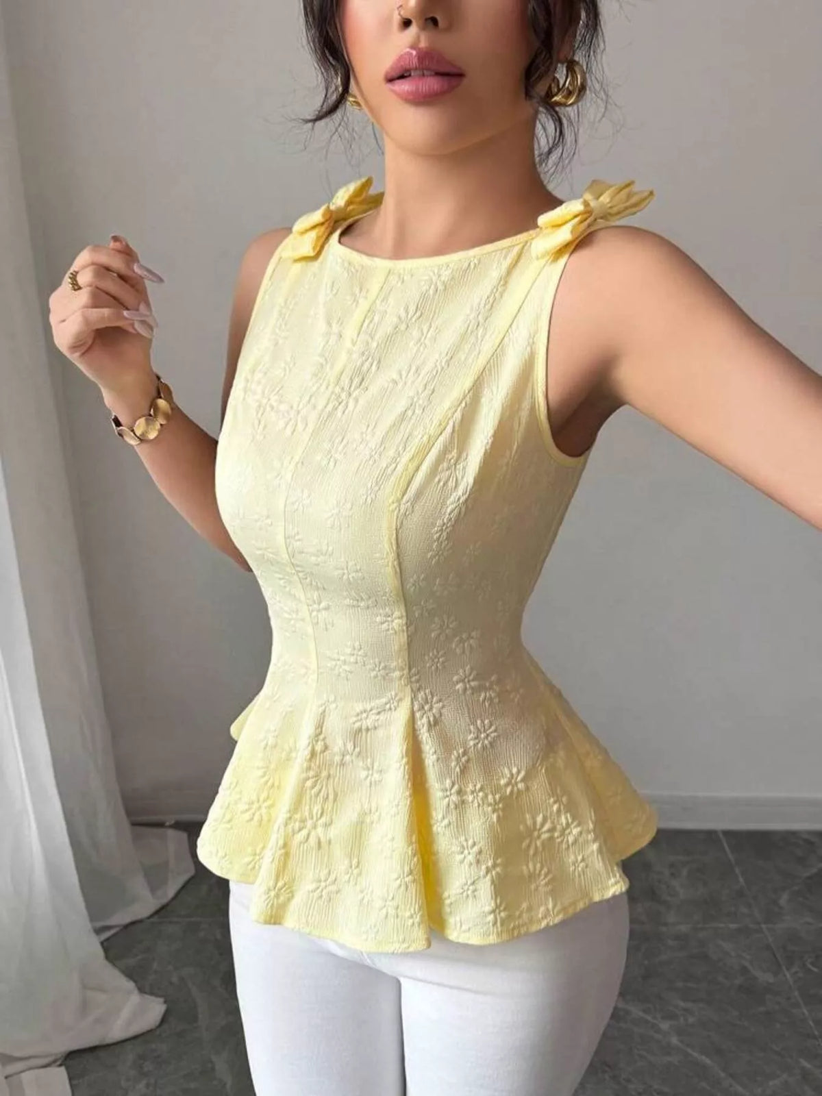 Bow shoulder peplum tank top detail view