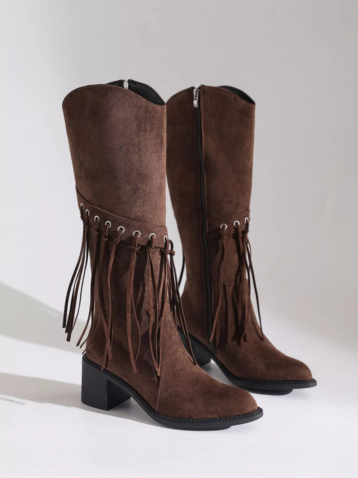 Fringe pointed toe block heel boots angled view