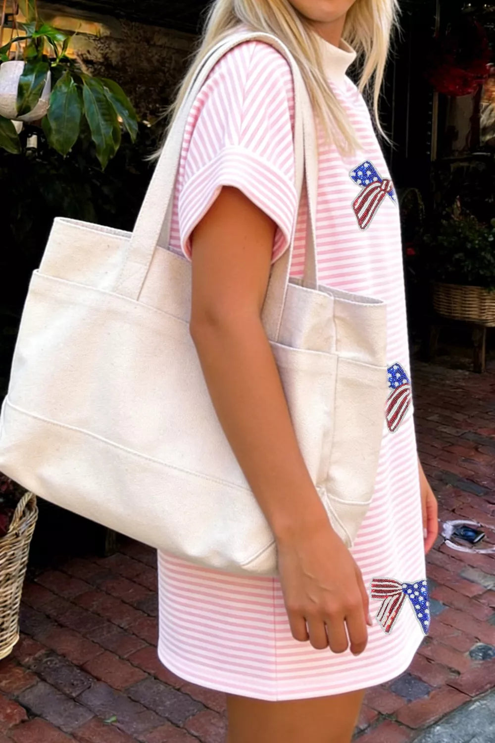 Blush pink striped bow sequin mini dress styled on model