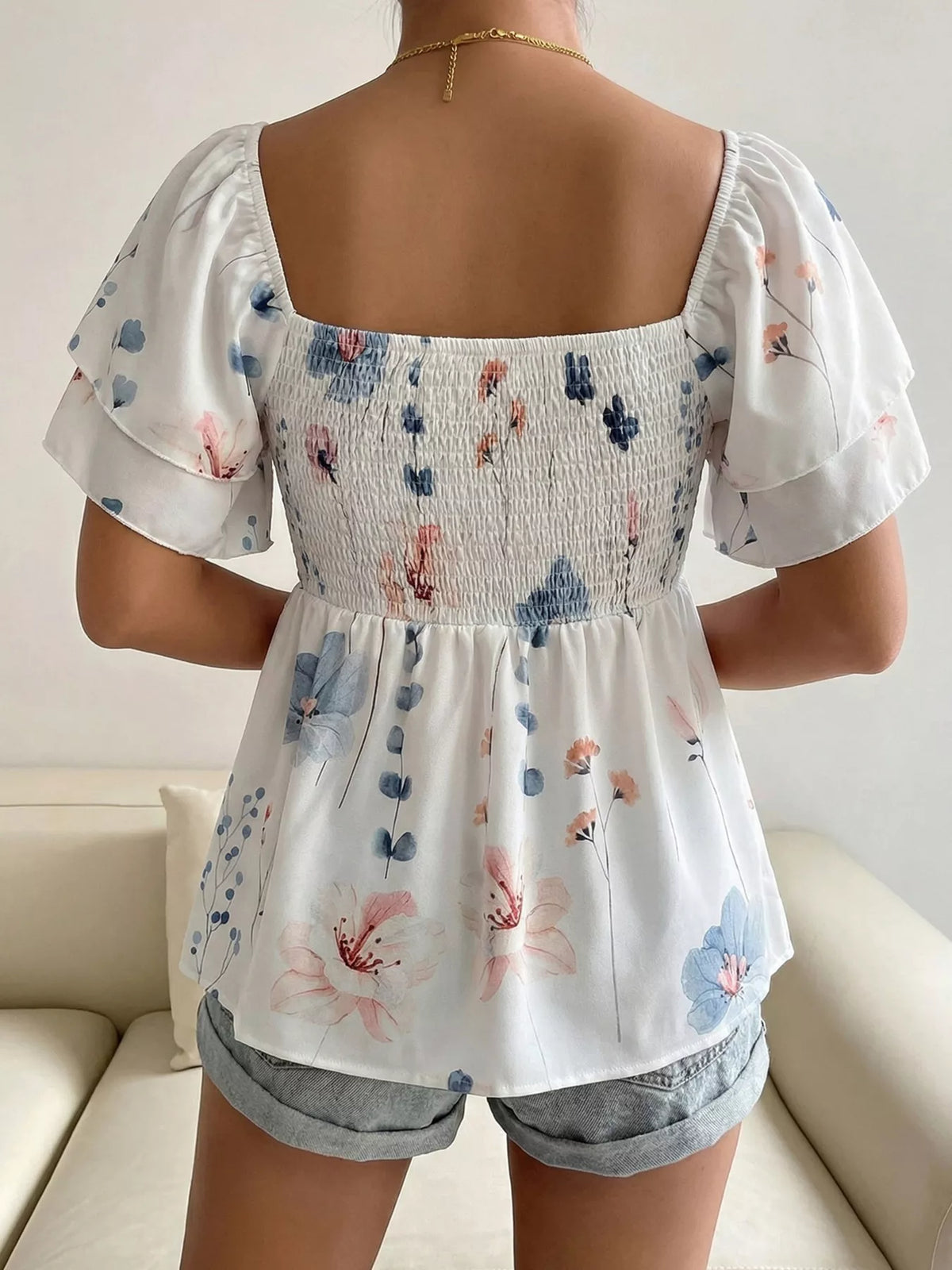 Close view of the square neckline and smocked panel detail