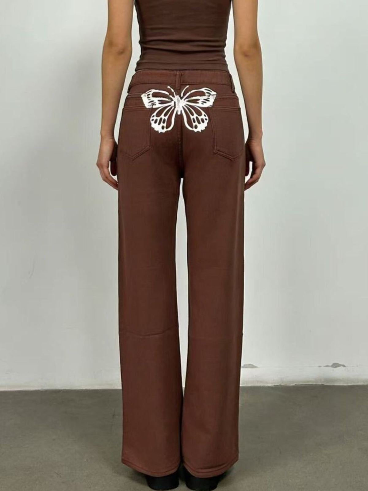 Detail of wide leg drape on butterfly jeans