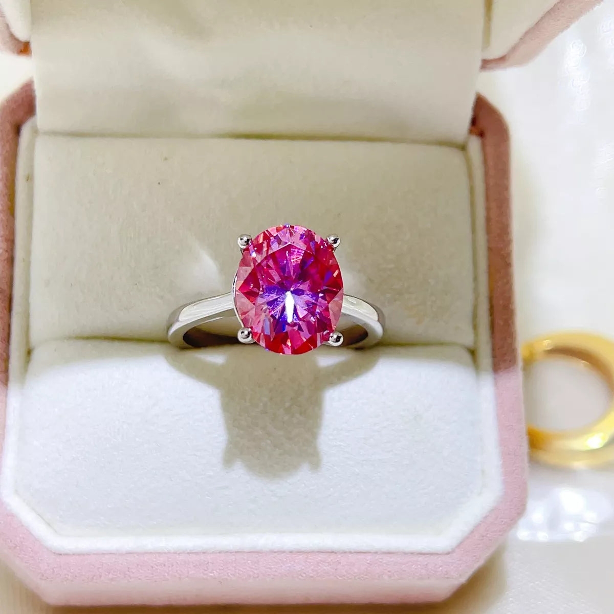 Hot pink moissanite ring shown from the side to display the setting