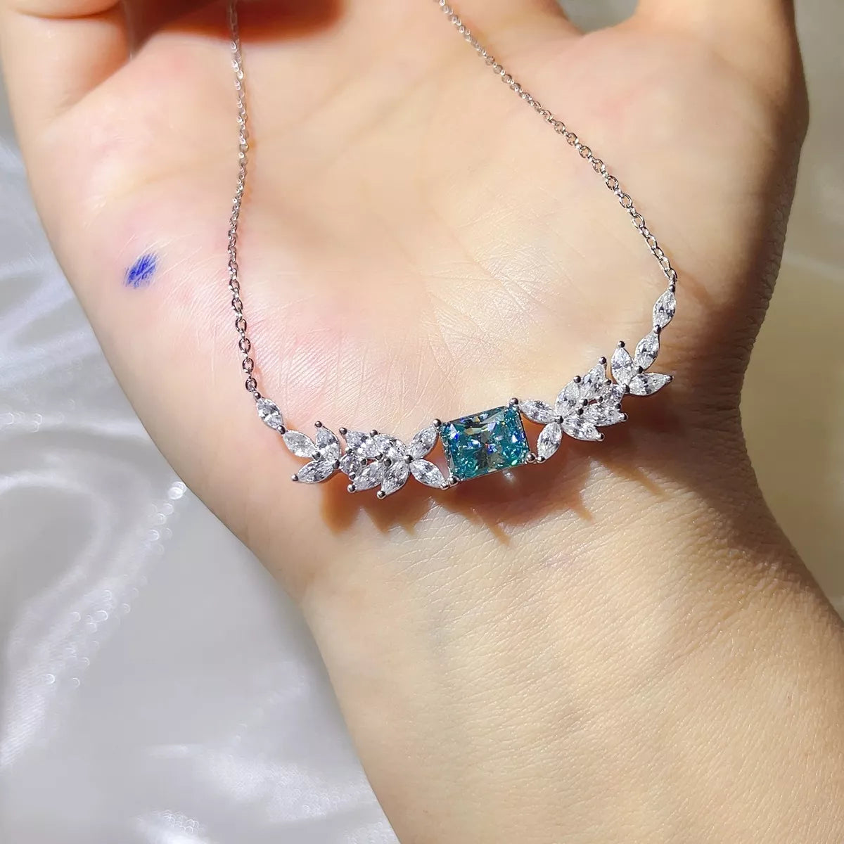 Moissanite necklace worn at the collarbone