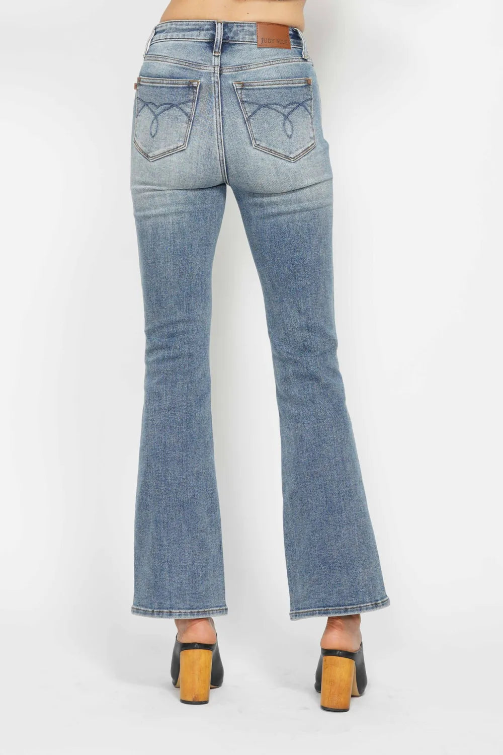 Back view showing the embroidered pocket detail on the jeans