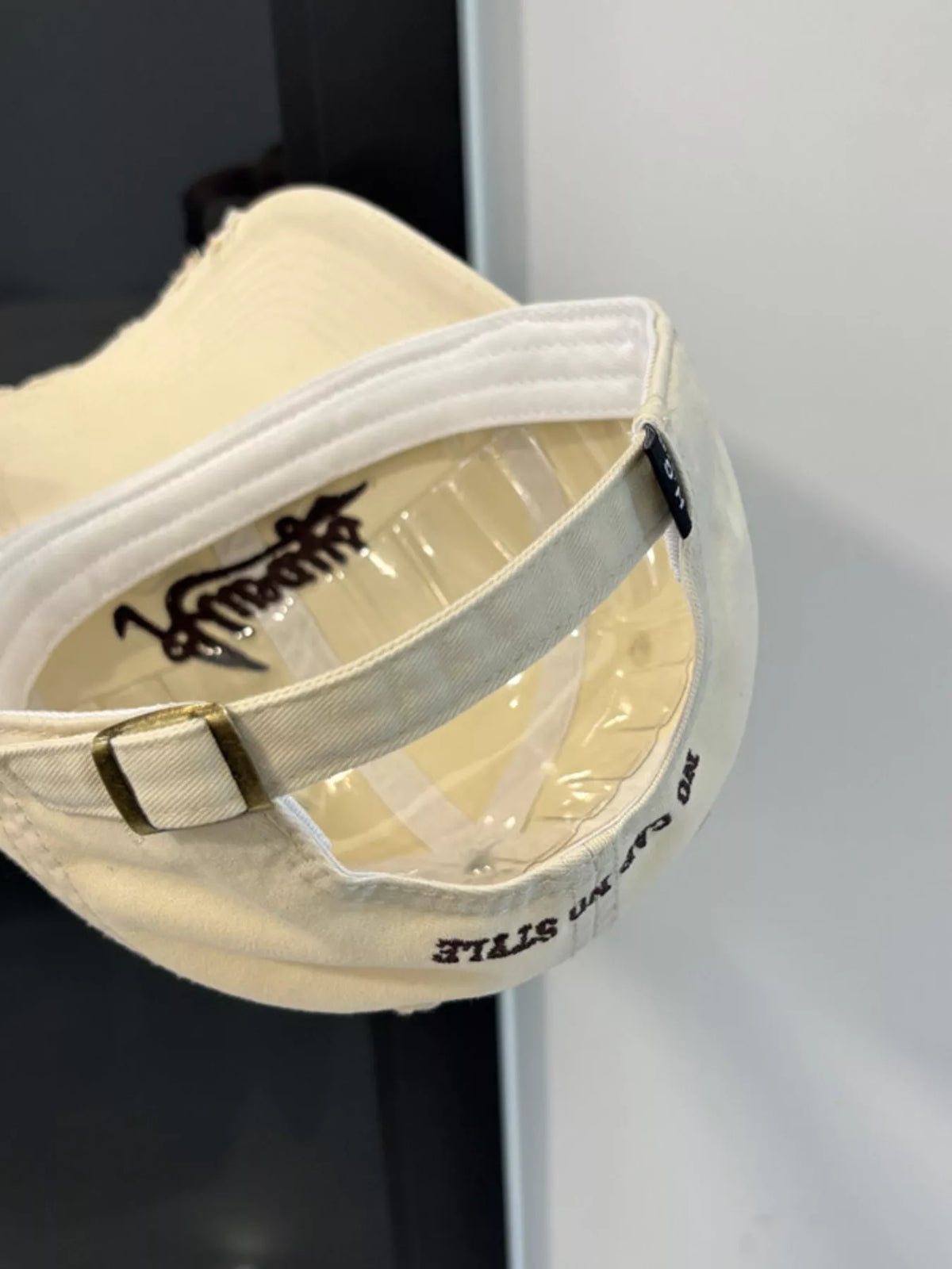 Side profile of the beige embroidered cap