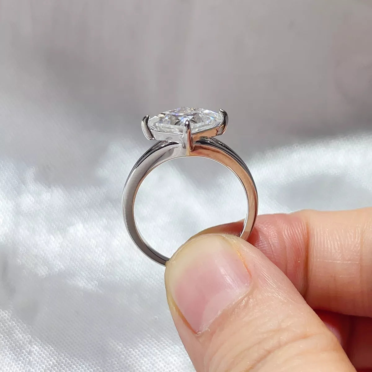 Close up of the 3 carat moissanite centre stone and silver band