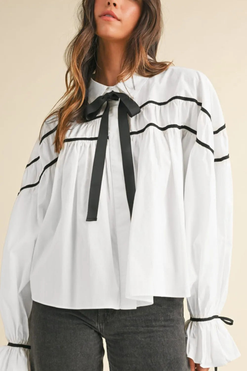 Flounce sleeve shirt styled with trousers