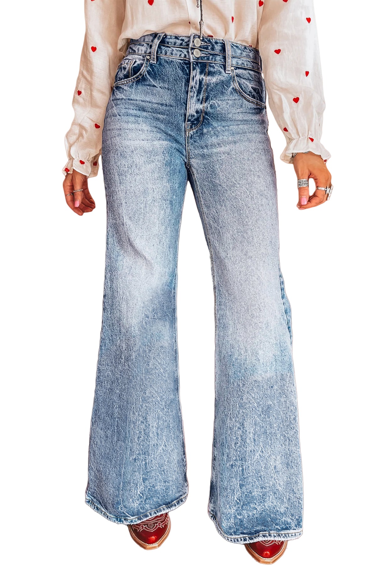 Blue acid wash flare jeans styled with a fitted top and boots