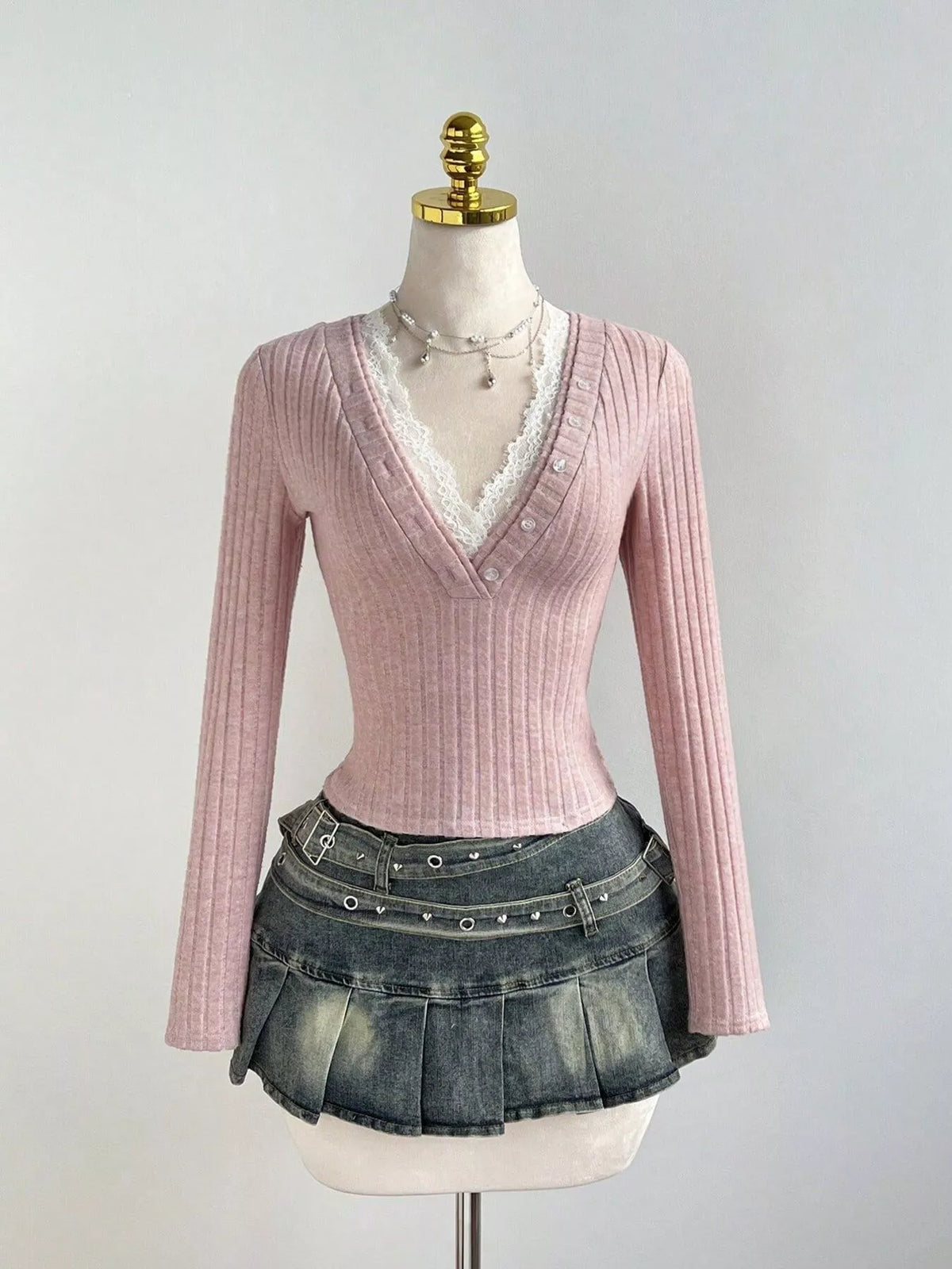 Close up of the lace and button detail on the knit top