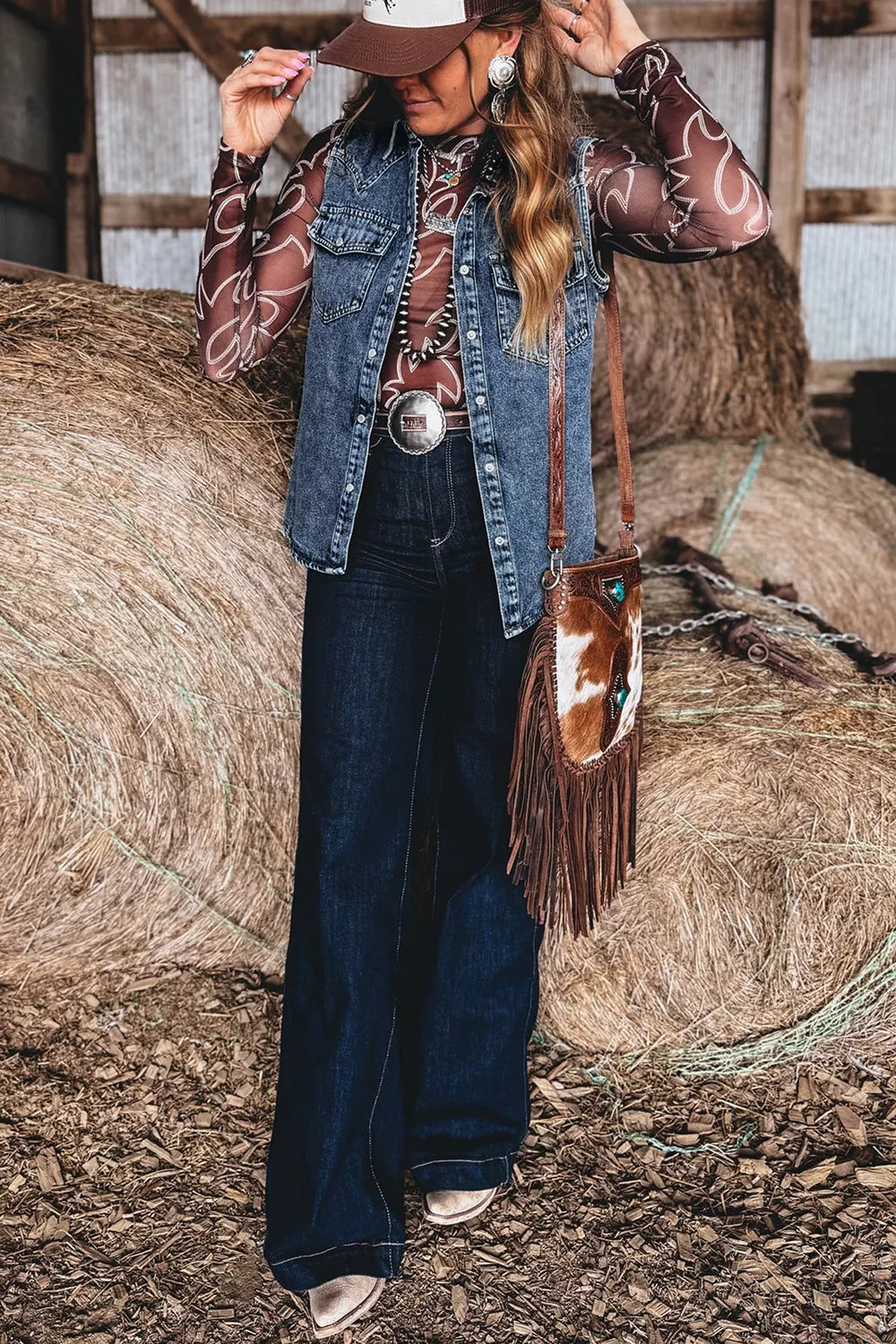 Close up of buttons and chest pocket on the denim vest