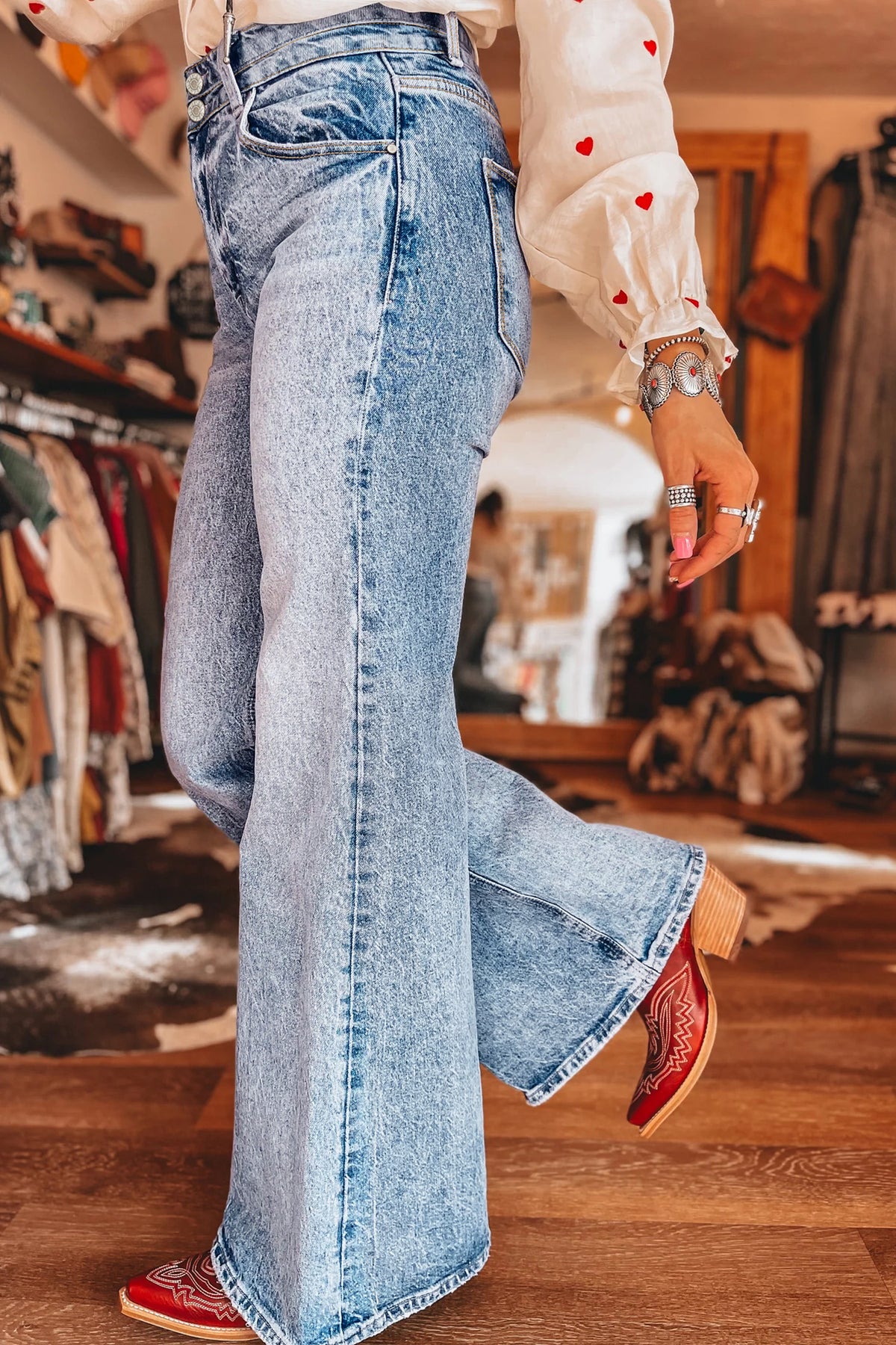 Blue acid wash flare jeans on model in a casual outfit