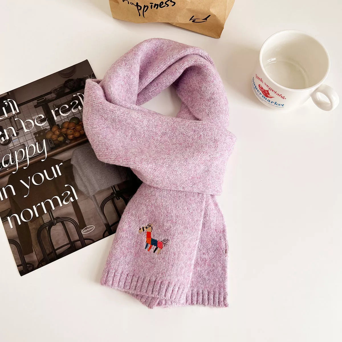 Embroidered scarf shown in a rich warm tone