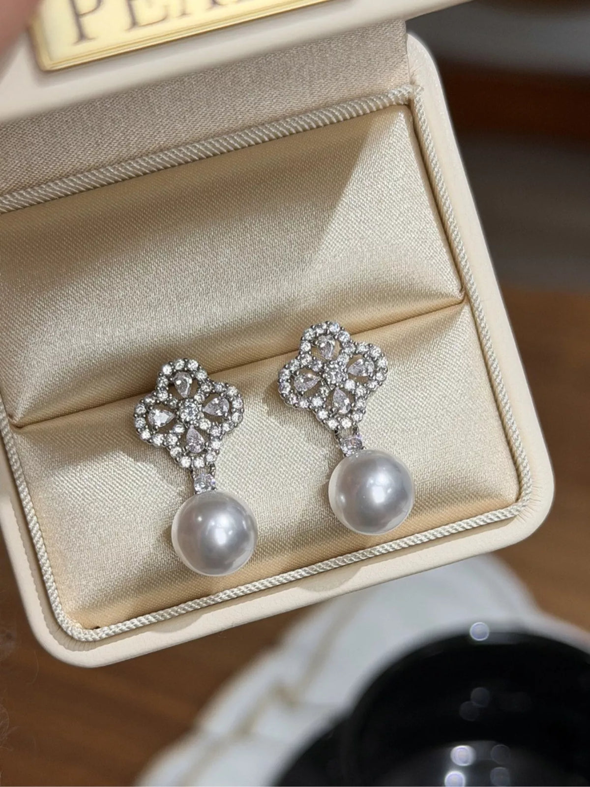 Silver four leaf clover pearl drop earrings front view