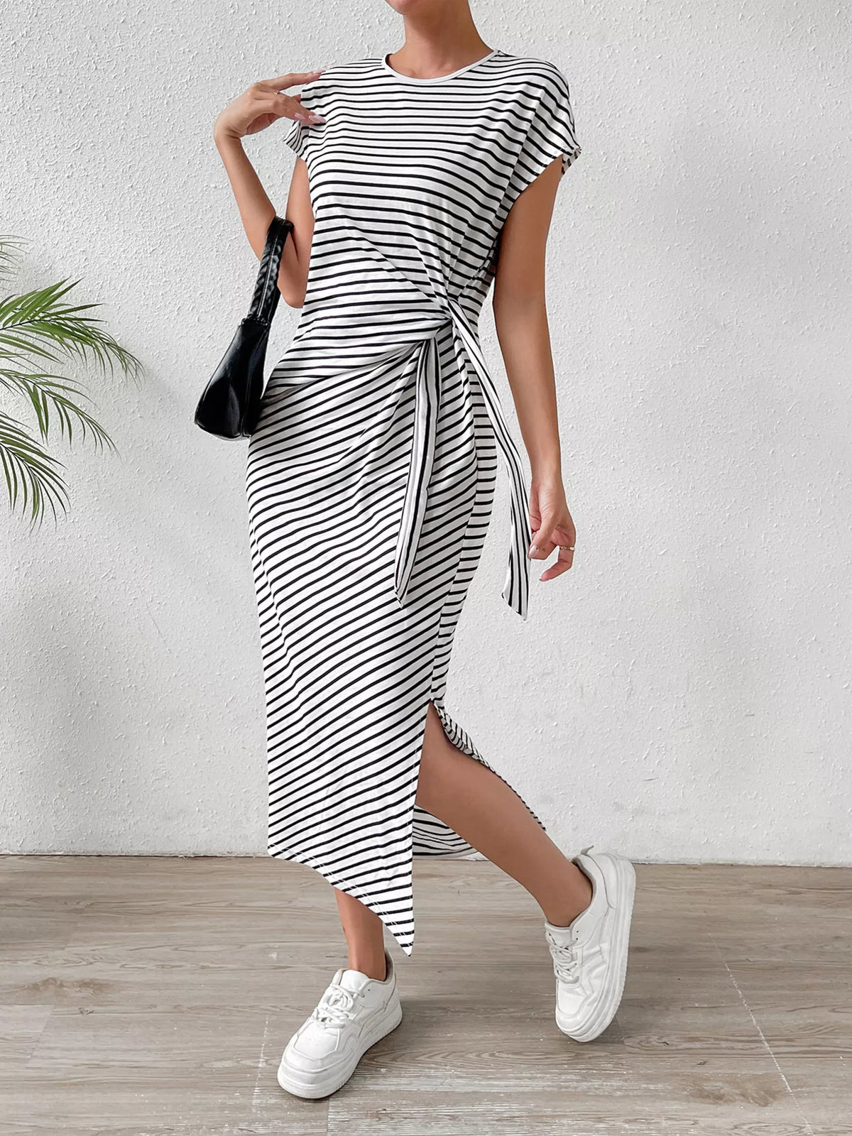 Side slit detail on the black striped dress