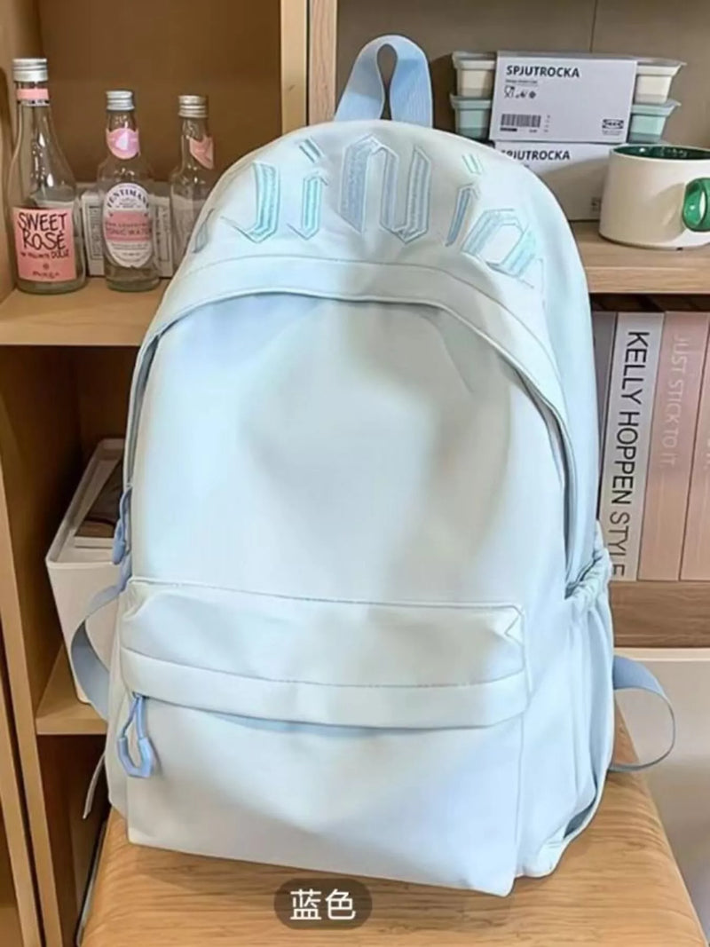 Embroidered letter nylon backpack in blue front view