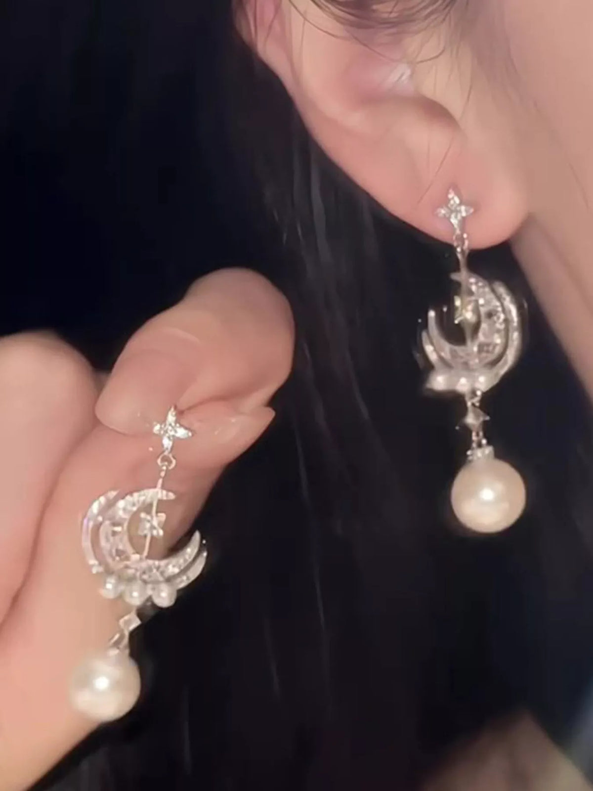 Moon and star pearl dangle earrings in silver tone, front view