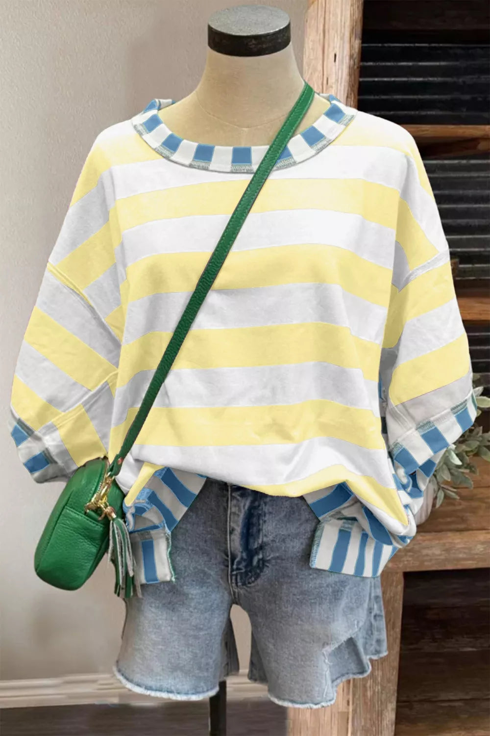 Relaxed fit striped top styled on model, side angle