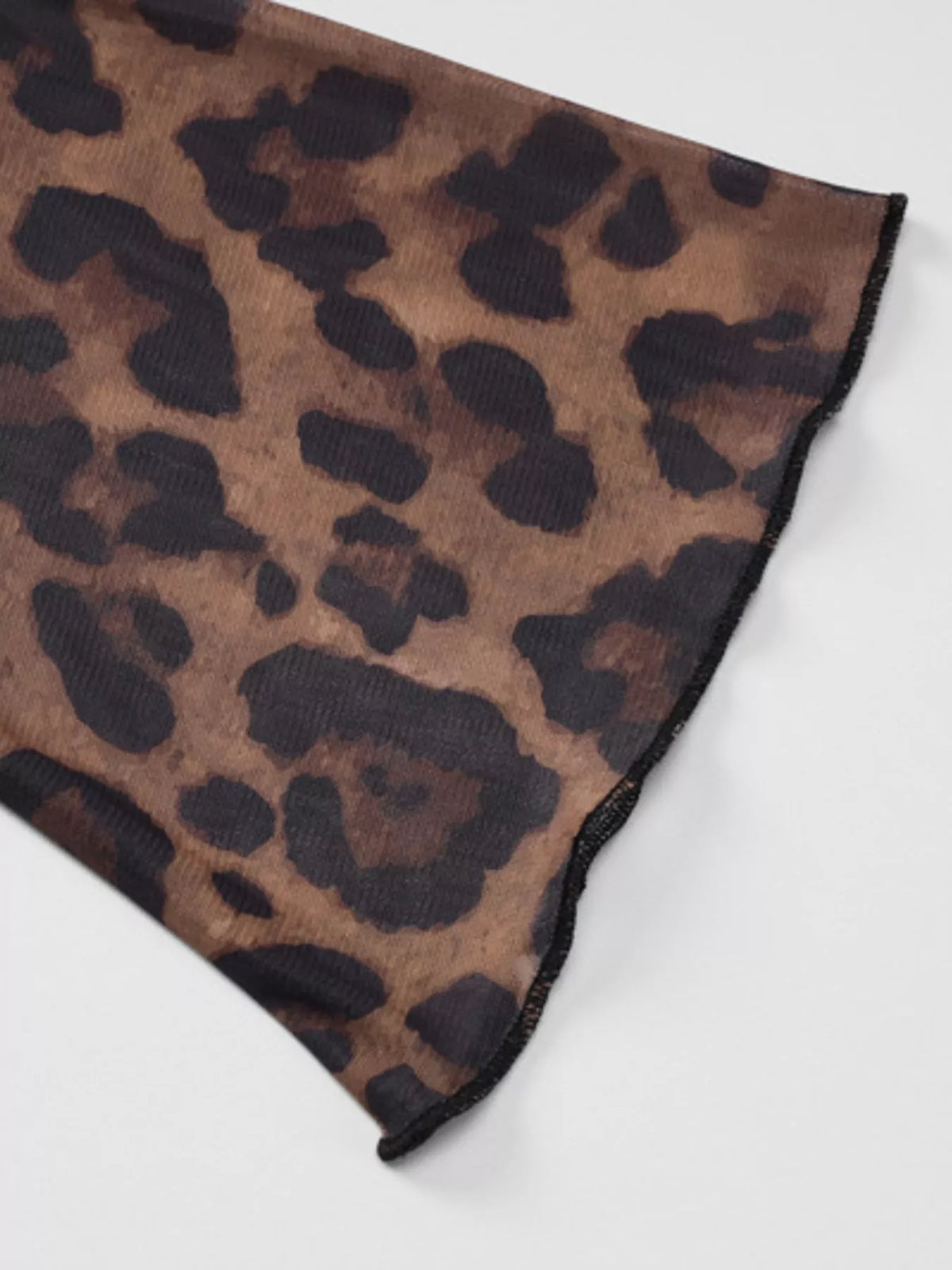 Layered styling of the leopard print top under a blazer