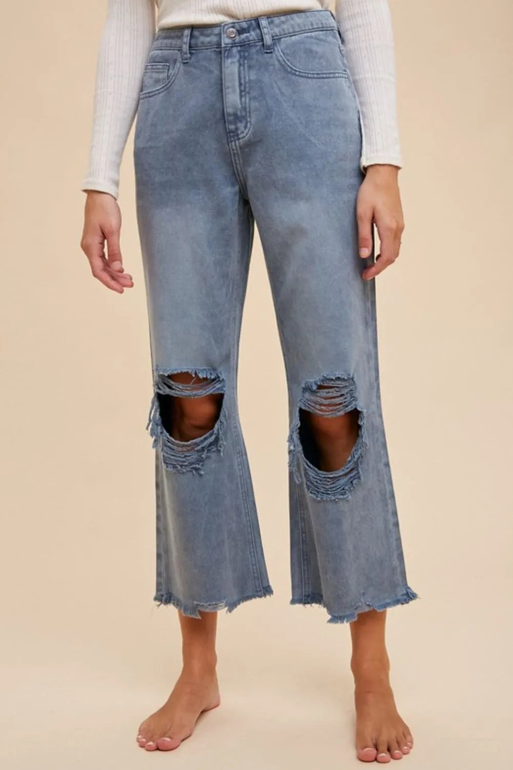 Dusty blue distressed raw hem jeans front