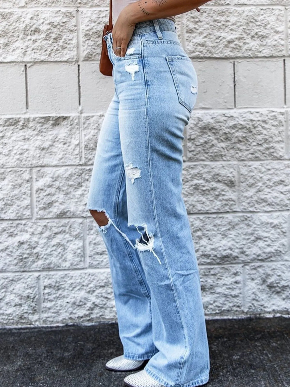 Distressed light blue denim side profile