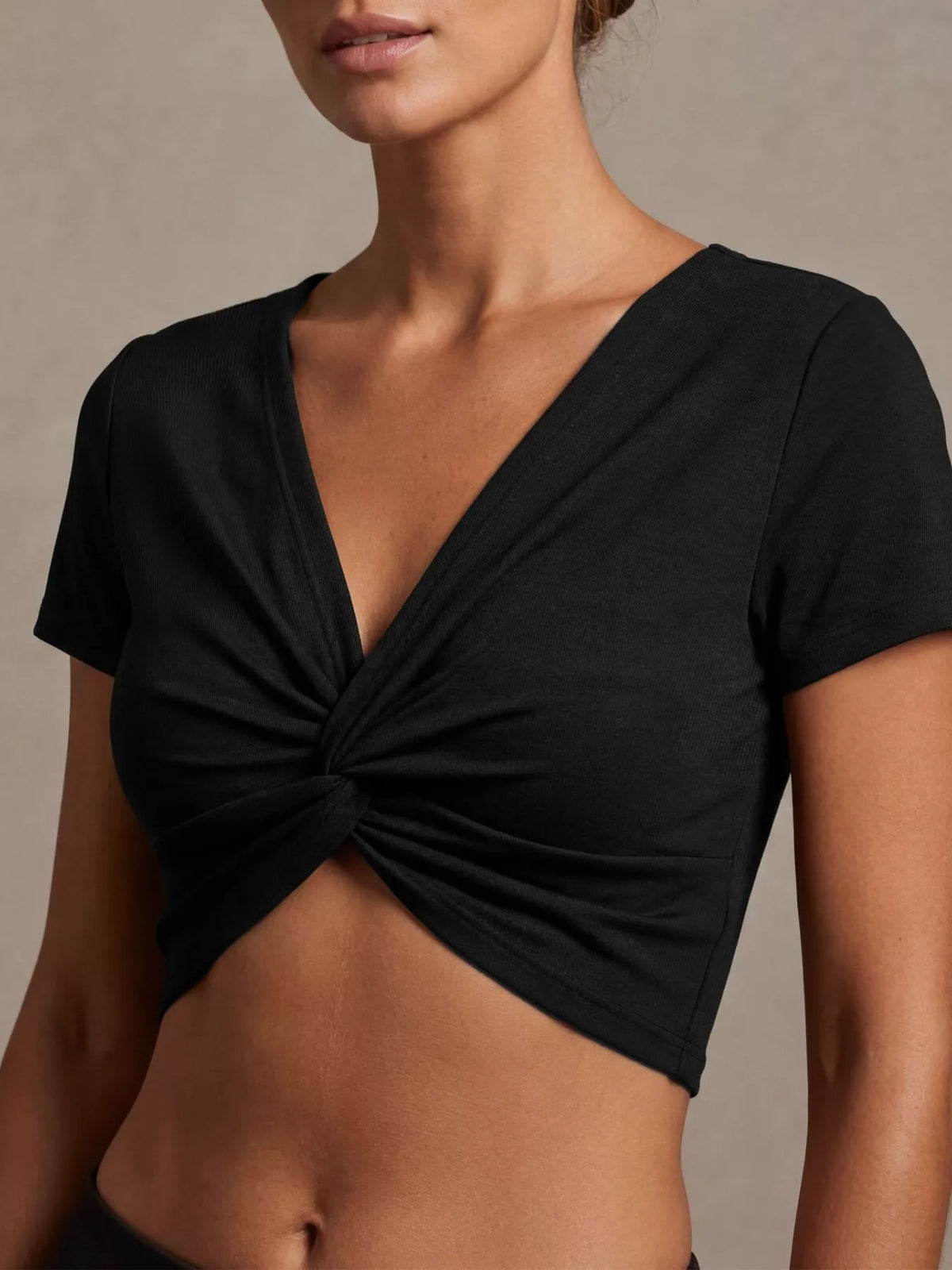 Black twist front cropped top, back view