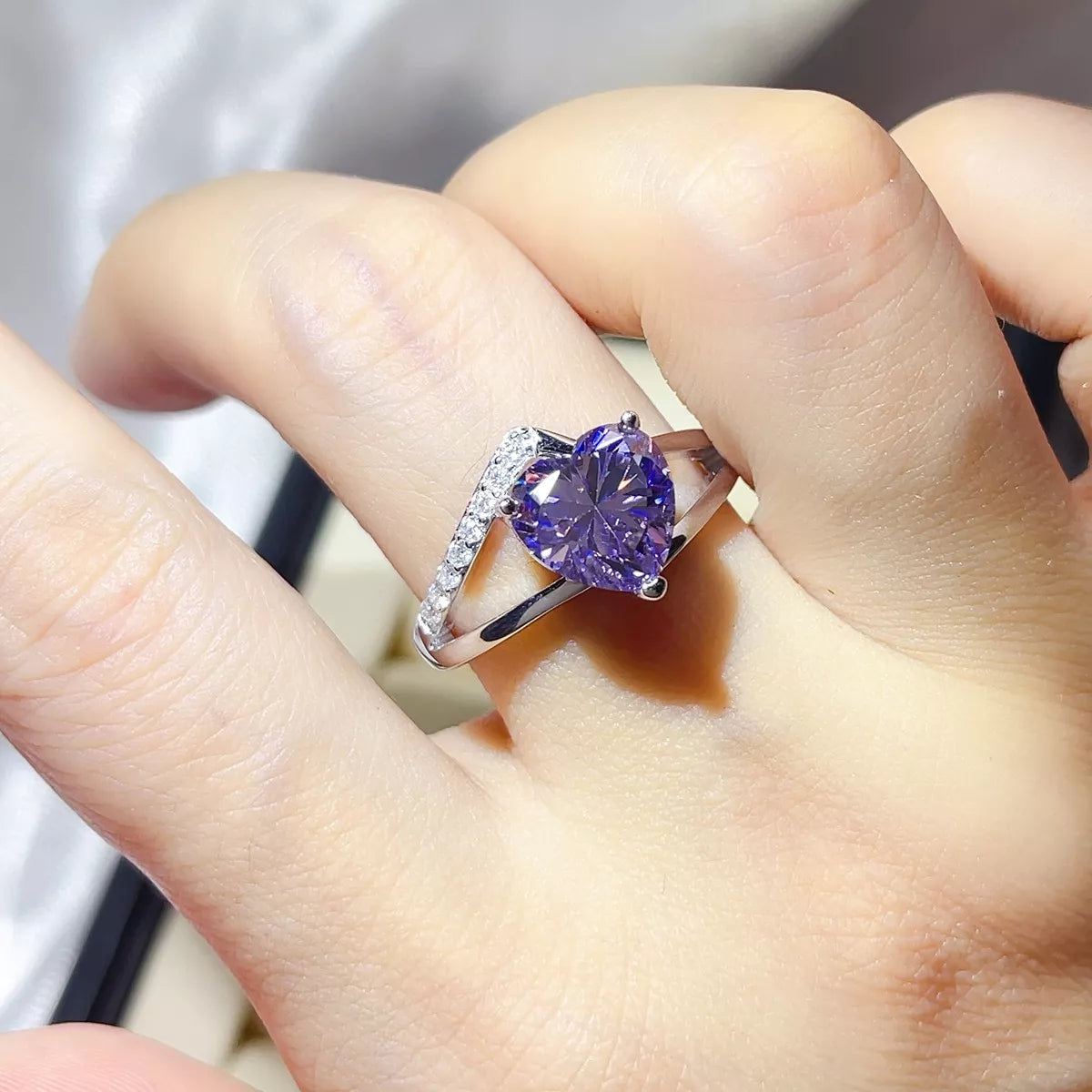 Close up of the blue purple moissanite stone and silver setting