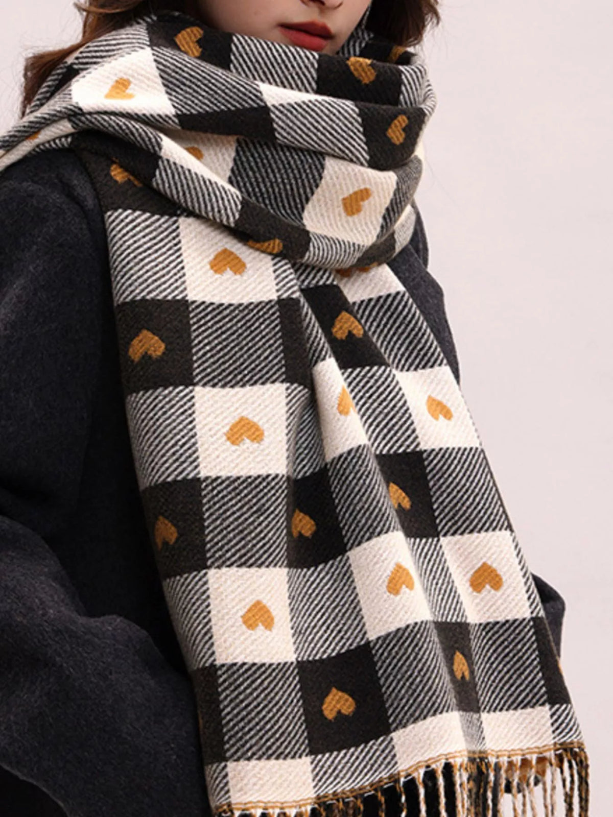 Heart plaid scarf showing tassel trim detail