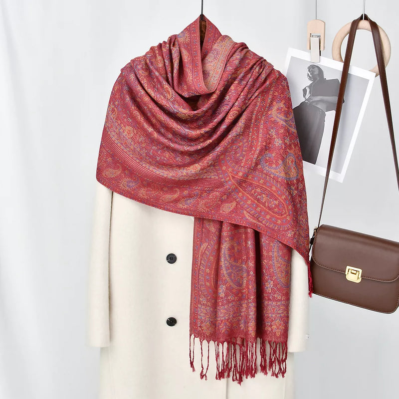 Paisley patterned raw hem scarf draped over the shoulders