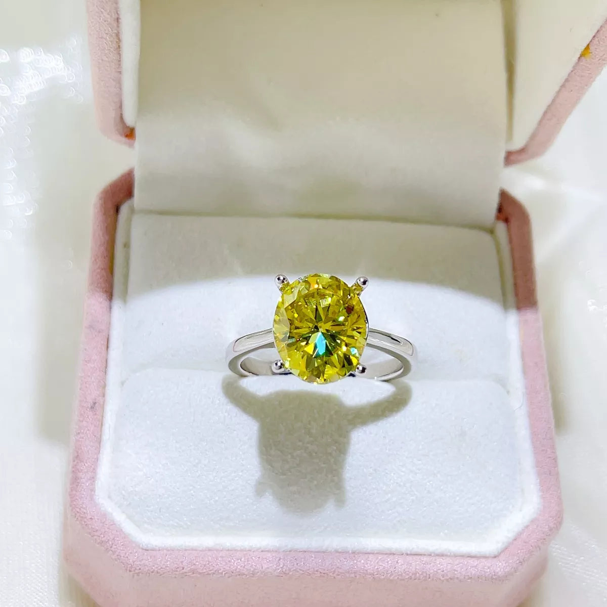 Close view of the light yellow moissanite stone and silver band