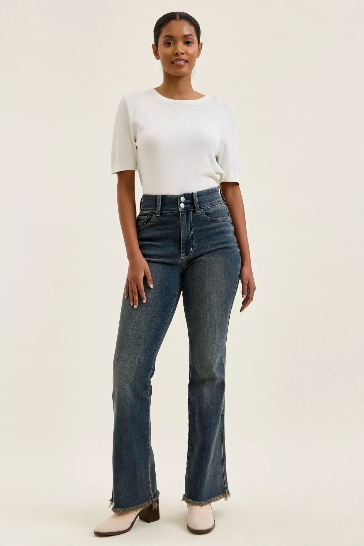 Full length styling of double button frayed hem jeans
