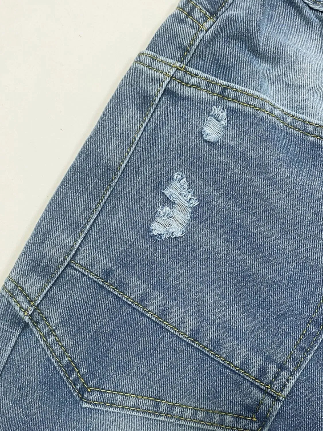 Model wearing distressed straight jeans