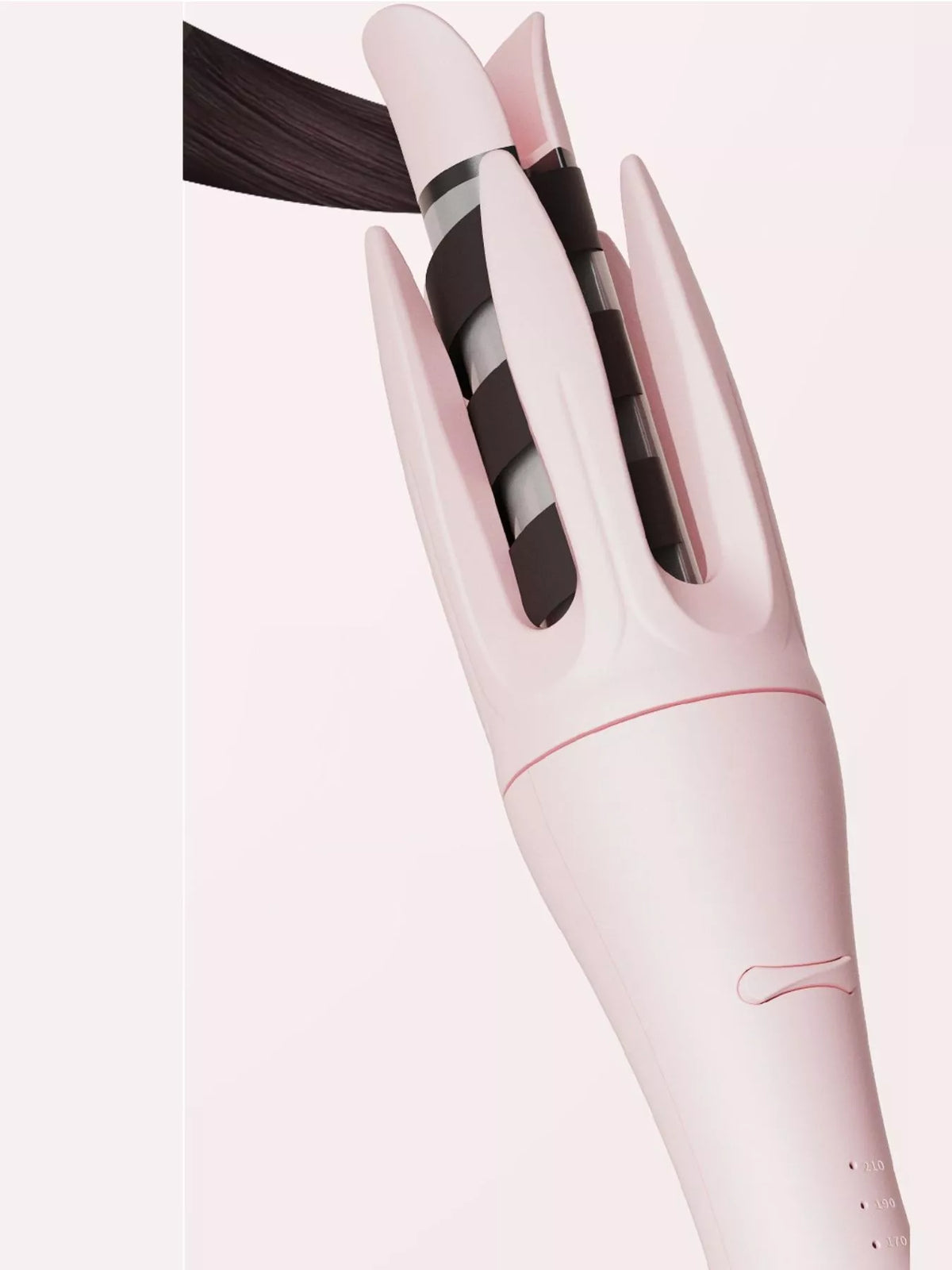 Beige automatic curler on a table