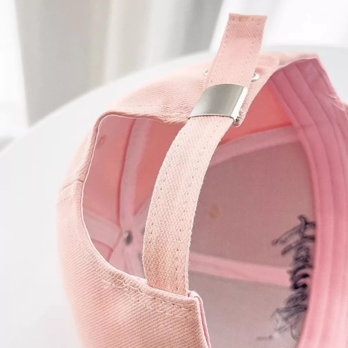 Pink distressed baseball cap shown from above