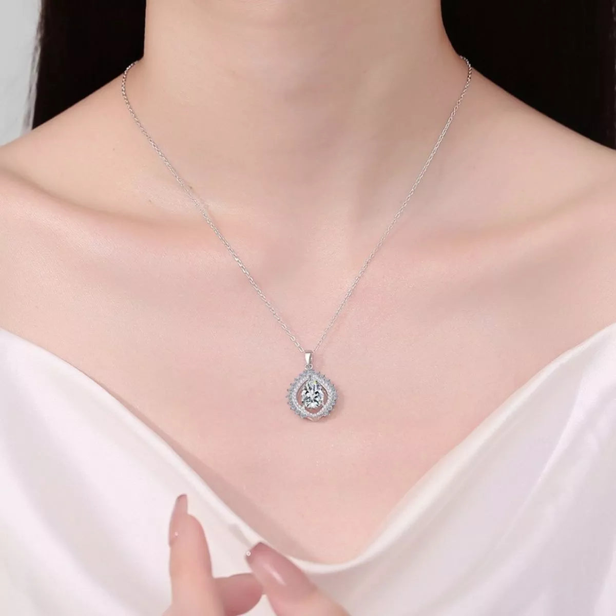 Teardrop moissanite necklace worn on the collarbone