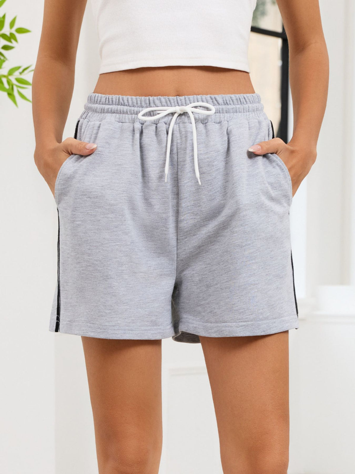 Striped trim drawstring shorts shown on model