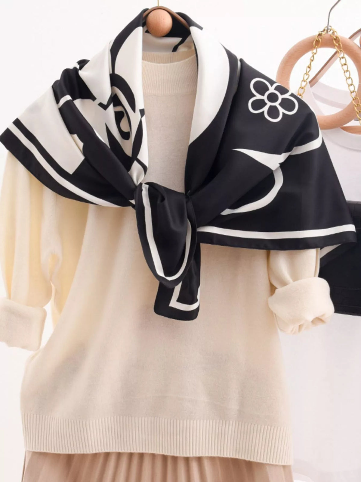 Floral square scarf knotted around a bag handle