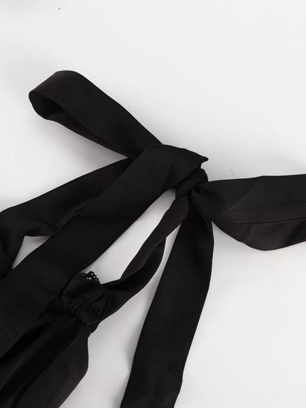 Neckline and shoulder tie detail of the dress