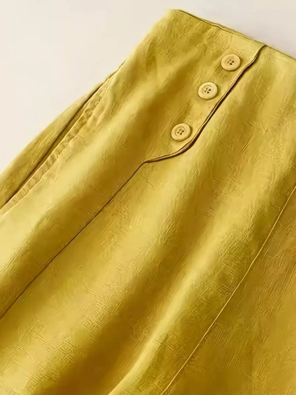 Wide leg cropped pants in yellow shown at full length from the back