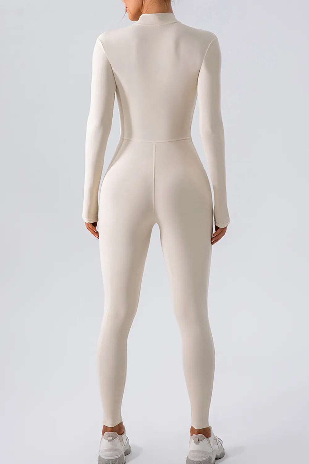 Half zip mock neck active jumpsuit strap detail