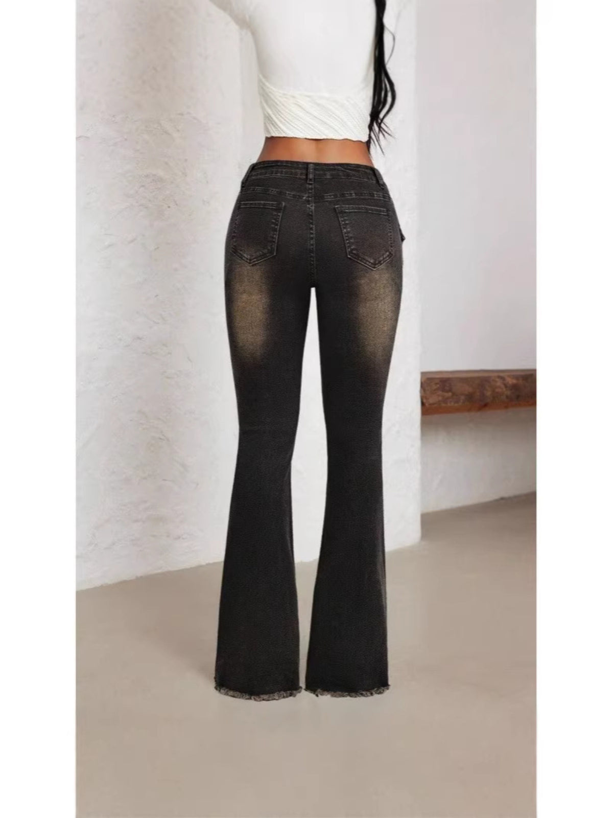 Close up of distressed black denim detail
