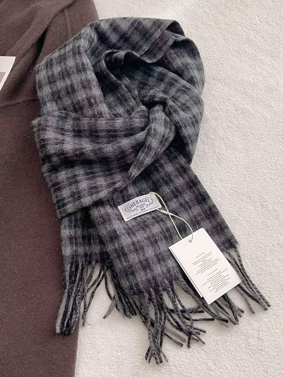 Close up of the plaid pattern and fringe detail