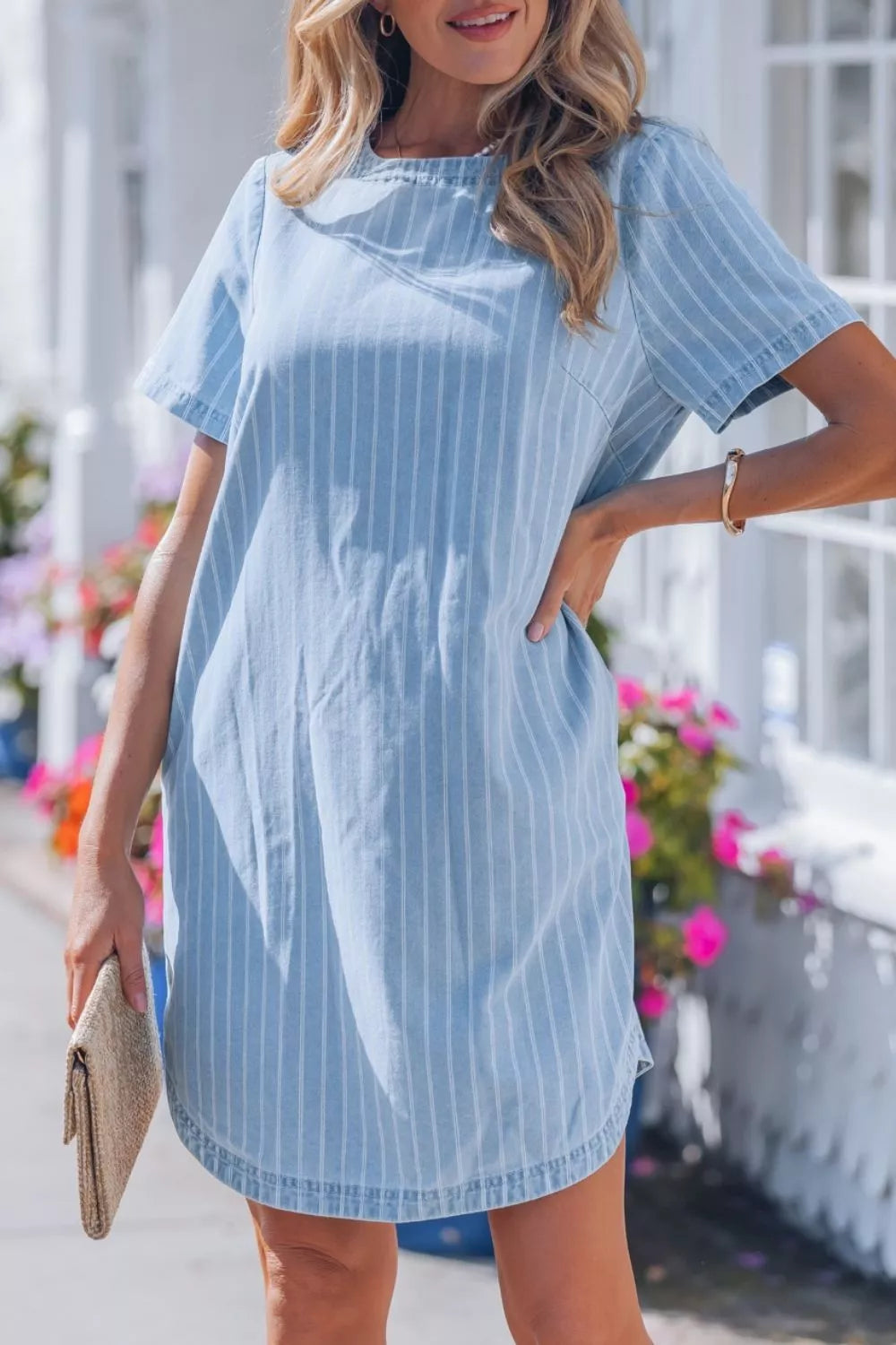 Light blue striped button back denim mini dress, front view