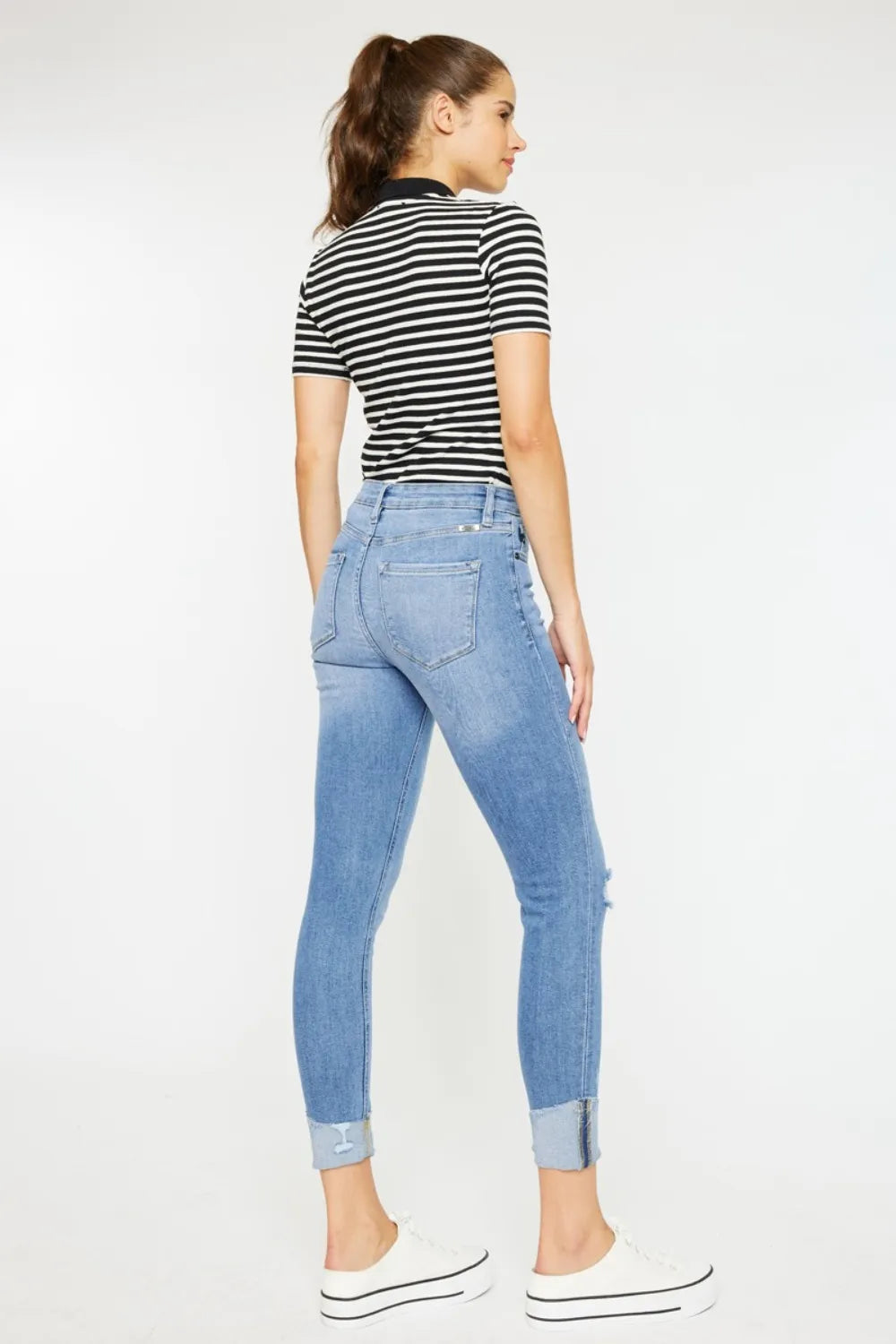 Light wash skinny jeans with whiskered fading side view