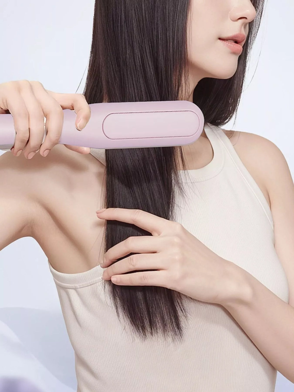Straightening comb in use on hair