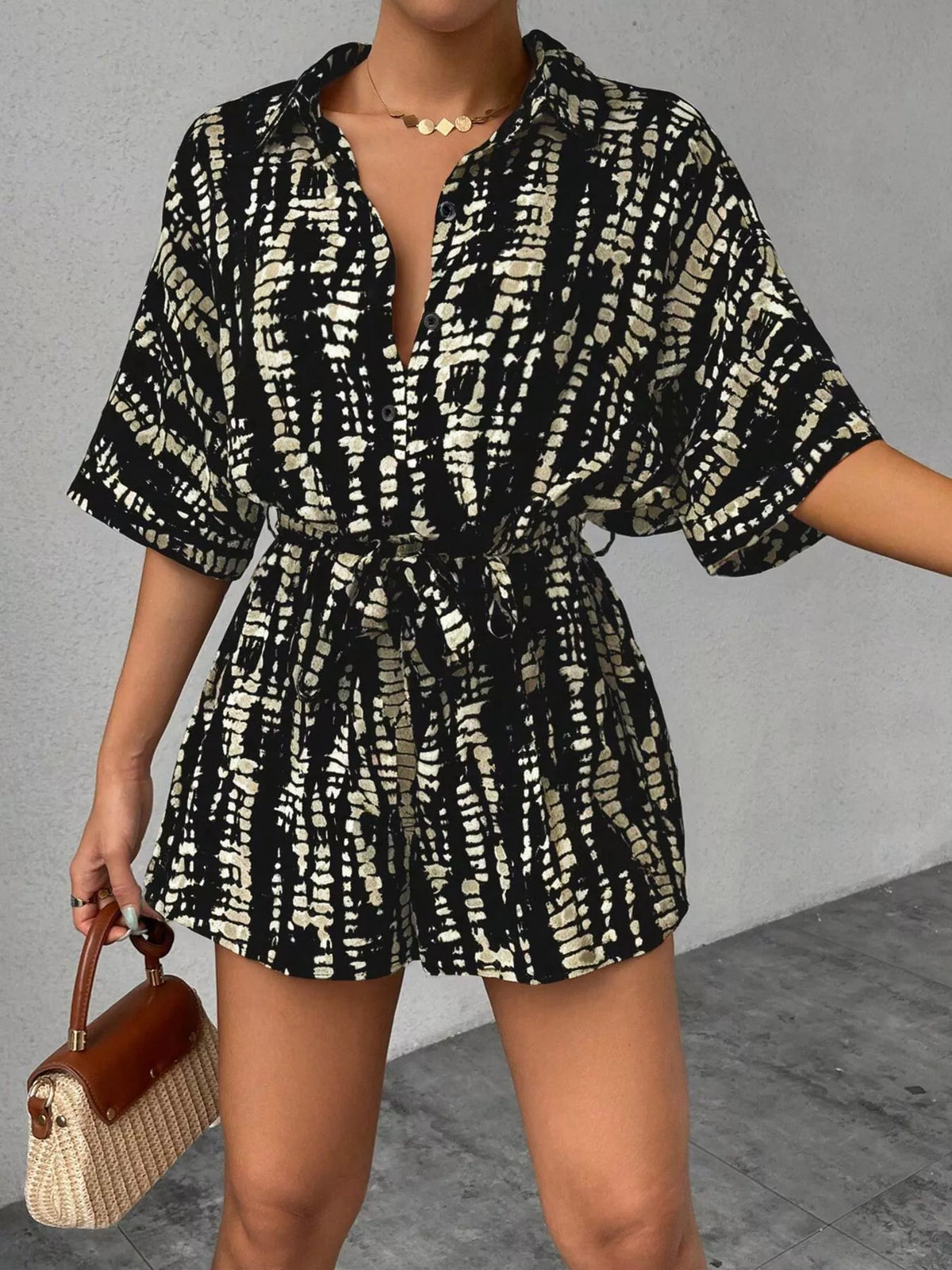 Romper styled with a straw bag