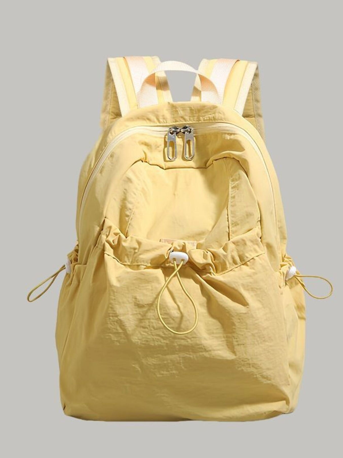 Drawstring backpack shown worn by model
